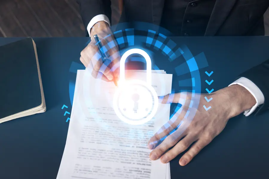 Man Signing Document With Illustration Of Lock Overlay